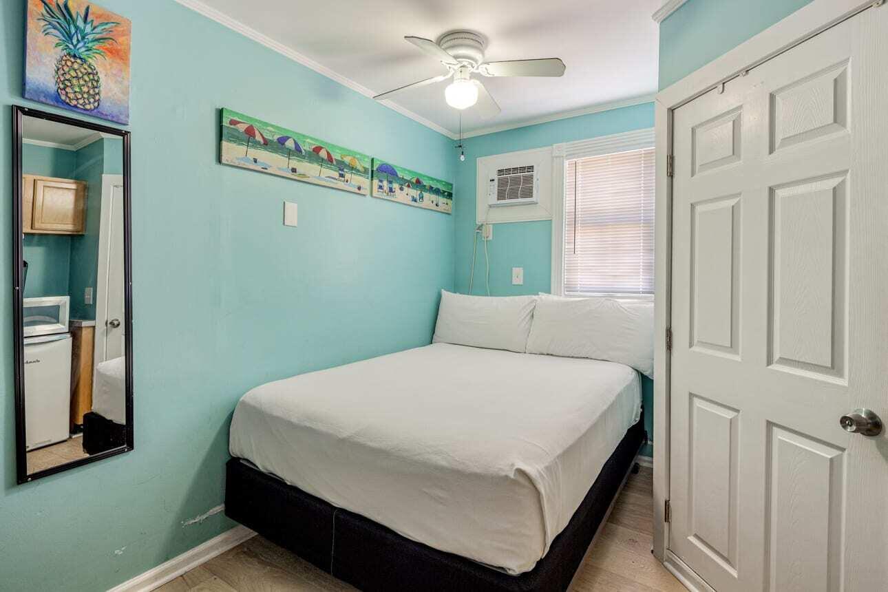 1016 Howe Street, Unit 5 Key West, FL 33040 - Photo 15 of 26 a bedroom with a bed and a window