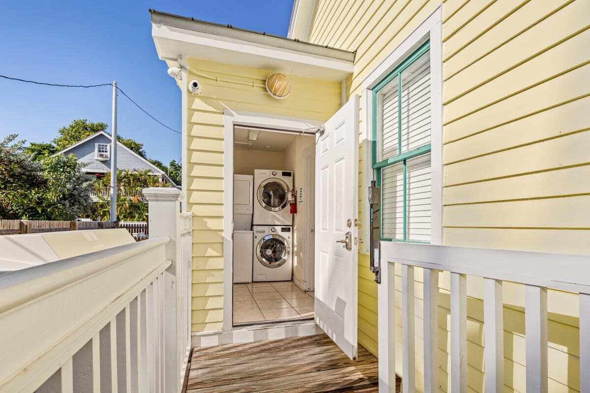 1016 Howe Street, Unit 5 Key West, FL 33040 - Photo 19 of 26 a view of a balcony with wooden floor and fence