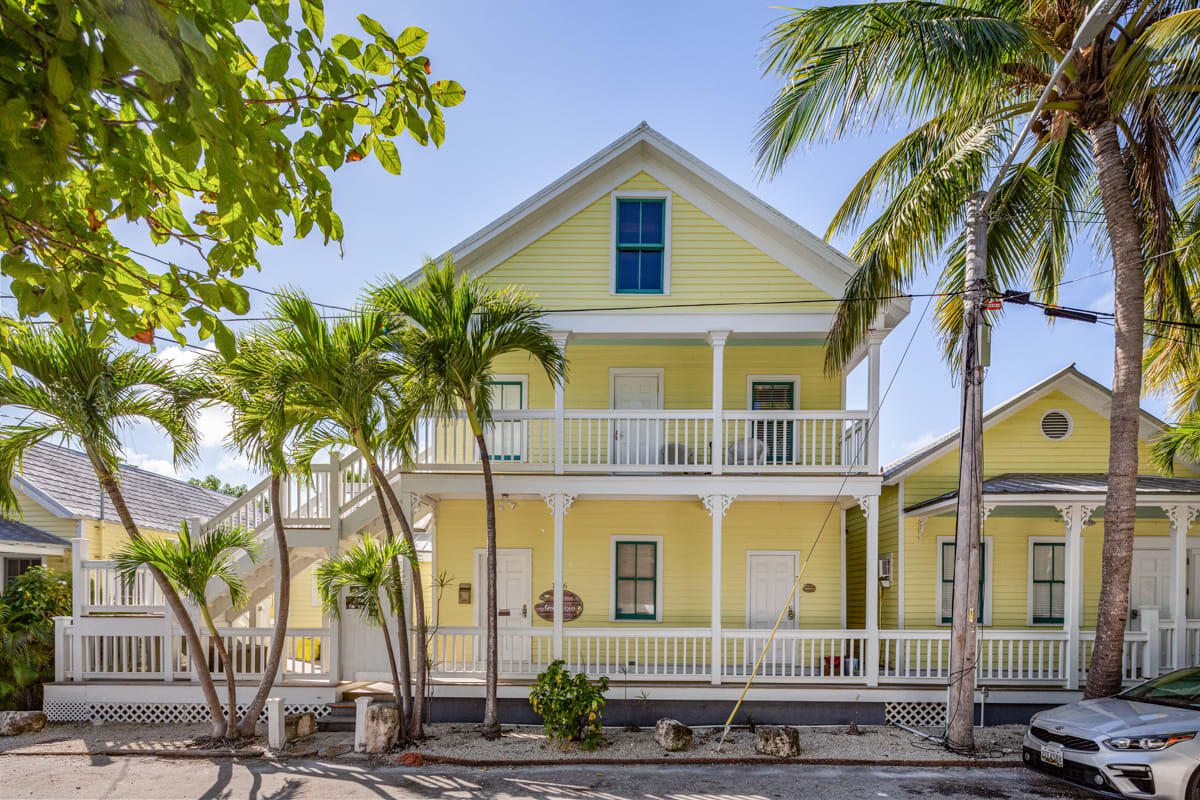 1016 Howe Street, Unit 5 Key West, FL 33040 - Photo 7 of 26 a front view of a multi story residential apartment building with a yard