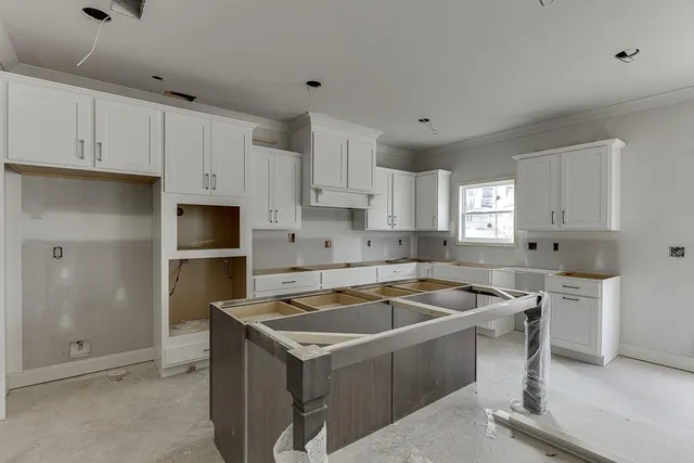 a kitchen with granite countertop a sink stove and refrigerator
