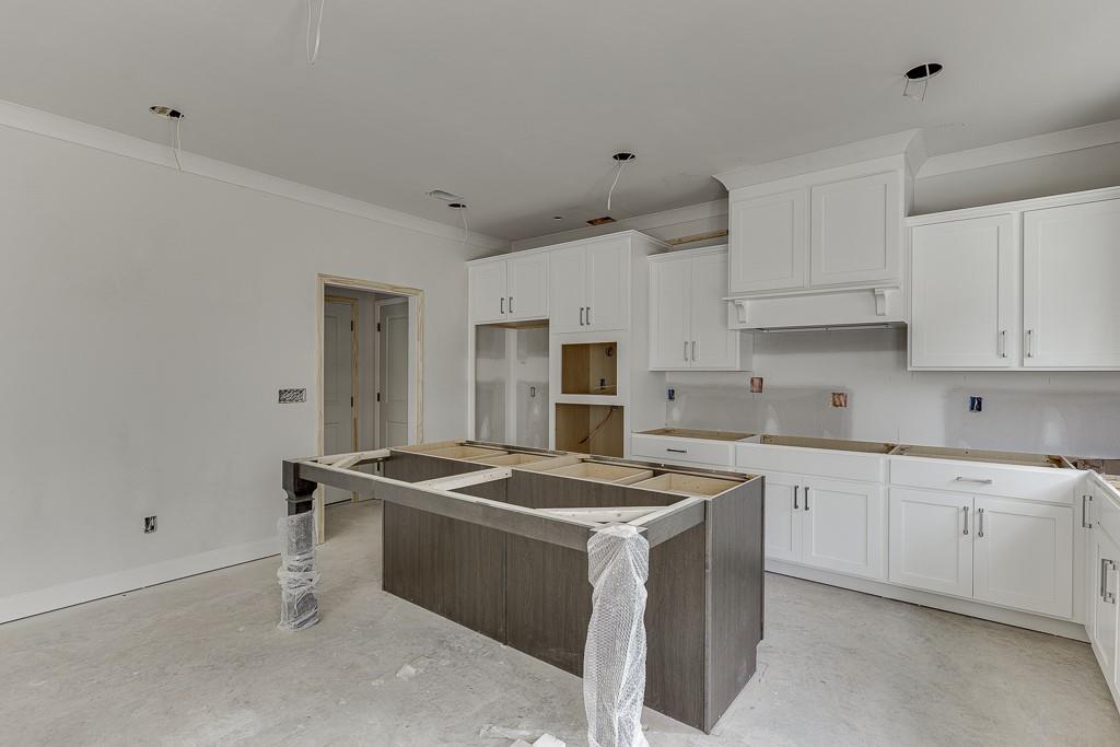 1075 Poppy Lane Jefferson, GA 30549 - Photo 15 of 36 a kitchen with granite countertop a sink stove and refrigerator