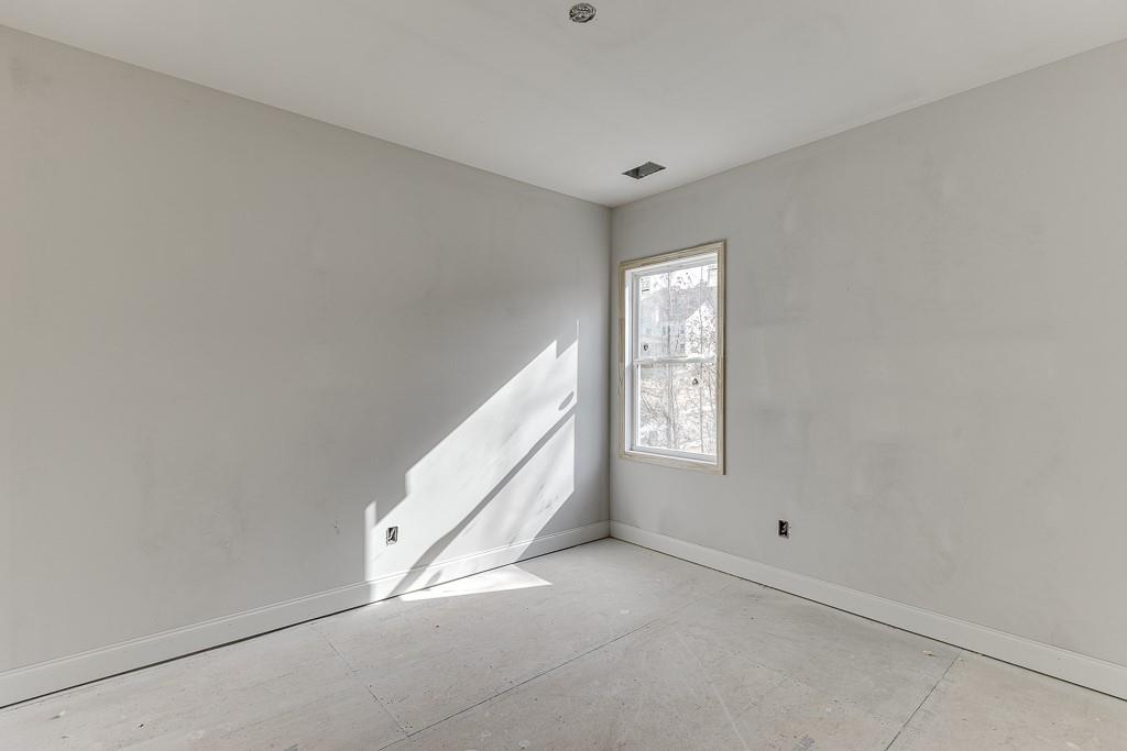 1075 Poppy Lane Jefferson, GA 30549 - Photo 19 of 36 a view of an empty room with window and hardwood floor