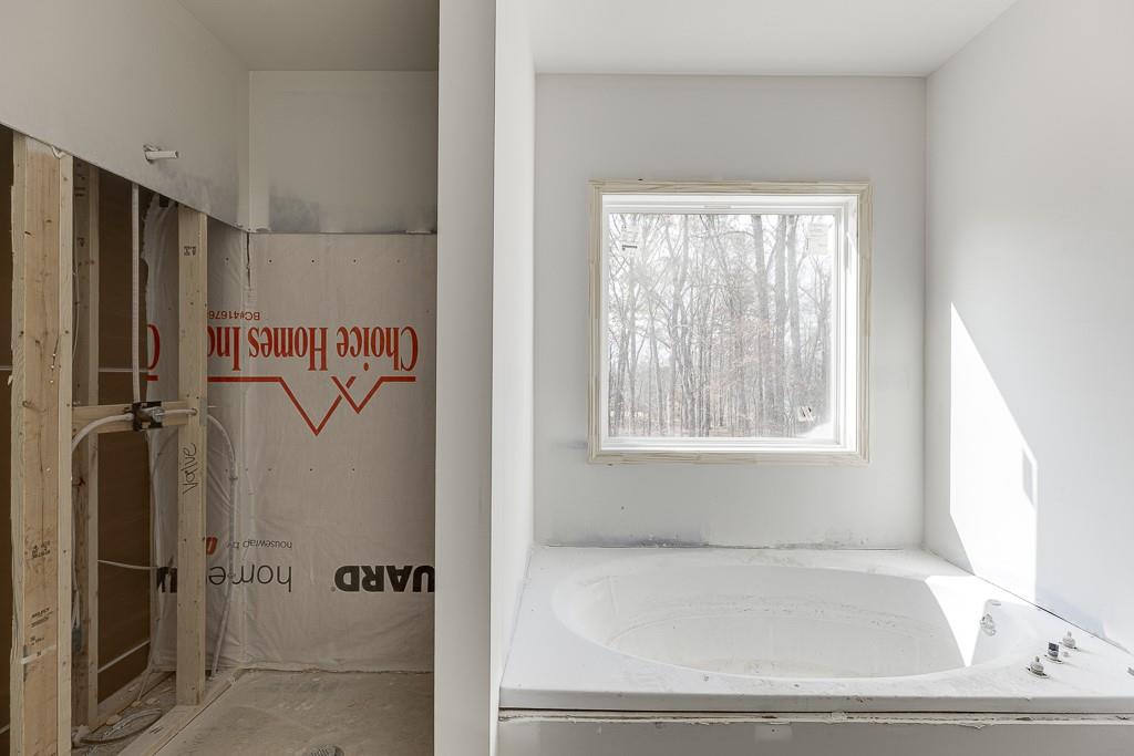 1075 Poppy Lane Jefferson, GA 30549 - Photo 30 of 36 a bathroom with a bathtub and a shower