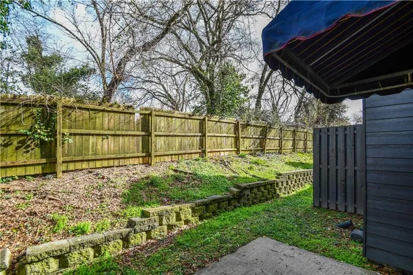 a view of a house with a large window and wooden fence