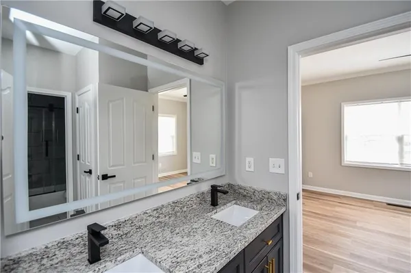 a large kitchen with granite countertop a stove a sink and a fireplace