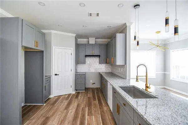 a bedroom with a bed and a large mirror on the dresser