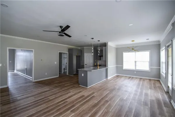 wooden floor fireplace and windows in an empty room