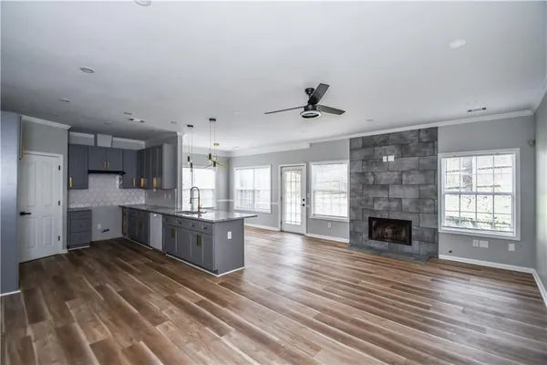 wooden floor fireplace and windows in an empty room