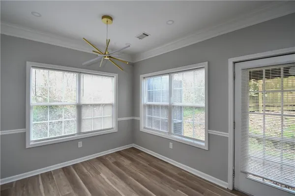 a view of an empty room and wooden floor