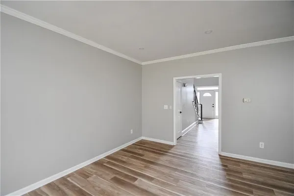 a view of a room with wooden floor and ceiling fan
