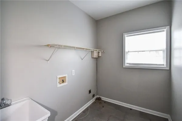 a view of empty room with wooden floor and ceiling fan