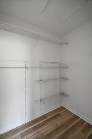 a view of a room with wooden floor and window