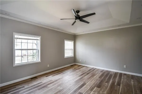 a bathroom with a granite countertop shower sink vanity and mirror