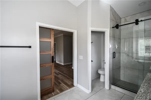 a view of a livingroom with wooden floor and white walls