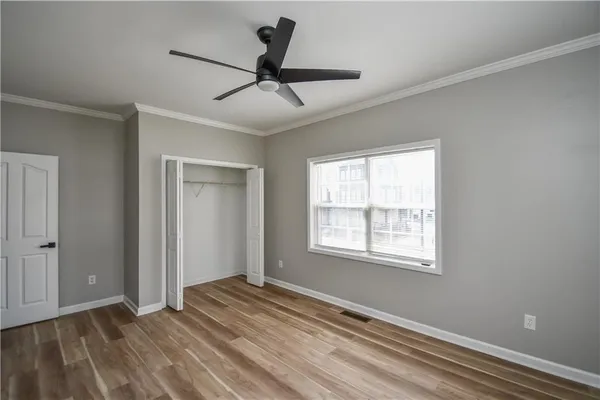 a view of a livingroom with a ceiling fan and window