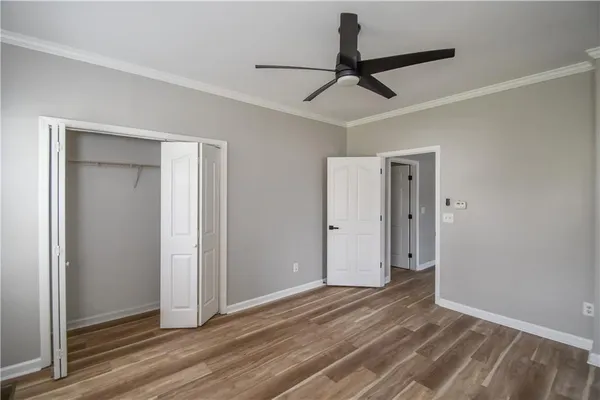 a view of empty room with wooden floor
