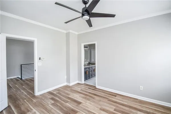 a view of a livingroom with wooden floor and a ceiling fan