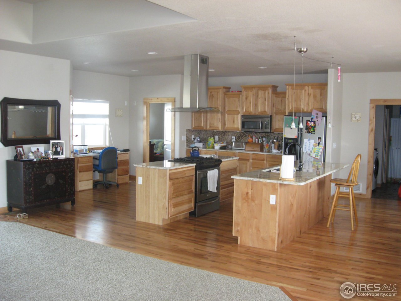 1303 Park Ridge Drive Severance, CO 80615 - Photo 2 of 10 a large kitchen with a table and chairs