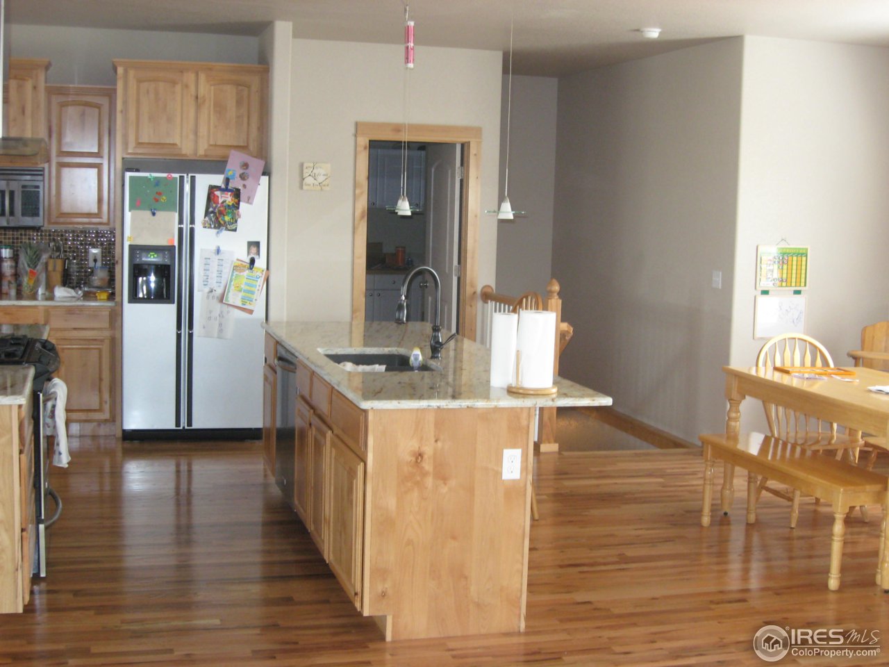 1303 Park Ridge Drive Severance, CO 80615 - Photo 3 of 10 a kitchen with stainless steel appliances granite countertop a refrigerator and a stove top oven