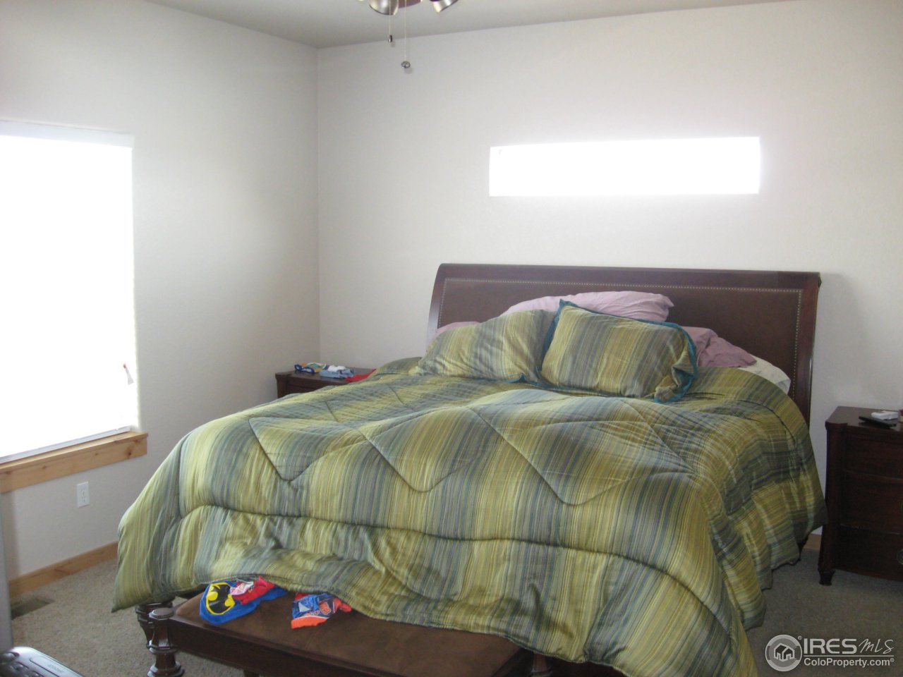 1303 Park Ridge Drive Severance, CO 80615 - Photo 4 of 10 a bedroom with a bed and a window