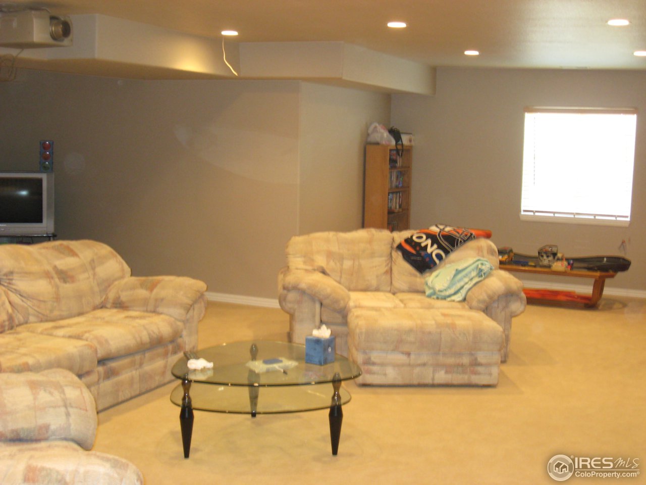 1303 Park Ridge Drive Severance, CO 80615 - Photo 8 of 10 a living room with furniture and a flat screen tv