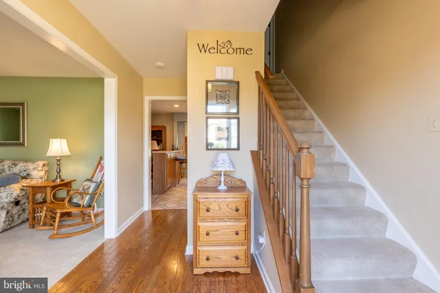 a view of a hallway with wooden floor windows and a livingroom