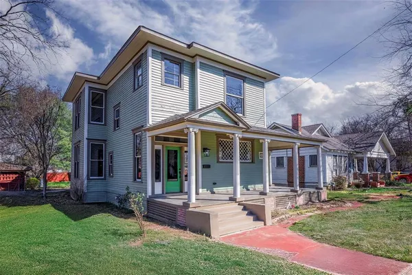 a front view of a house with garden and porch