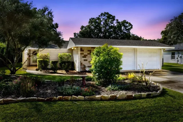 a front view of a house with a garden