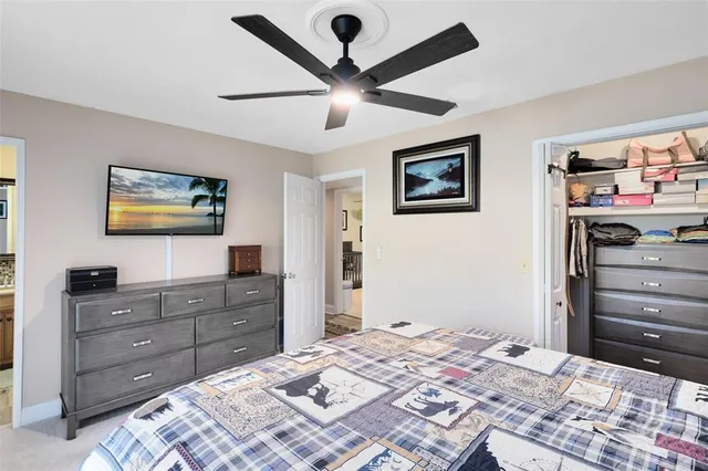 a bedroom with a bed and a dresser in it