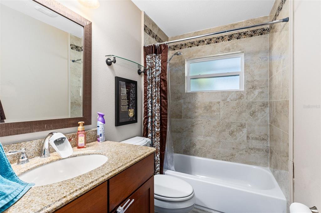 440 East Orange Street Altamonte Springs, FL 32701 - Photo 20 of 39 a bathroom with a granite countertop sink mirror toilet and bathtub