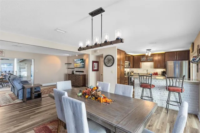 a view of a dining room with furniture a rug and wooden floor
