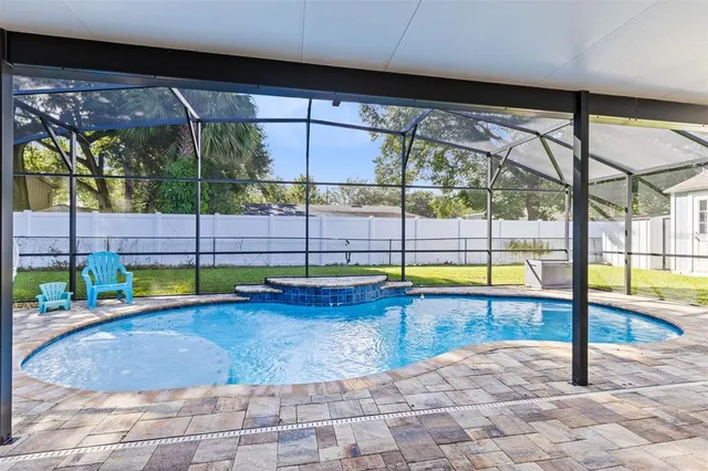 a view of a swimming pool with a yard
