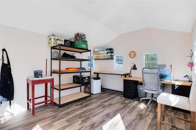 a living room with furniture a rug and white walls