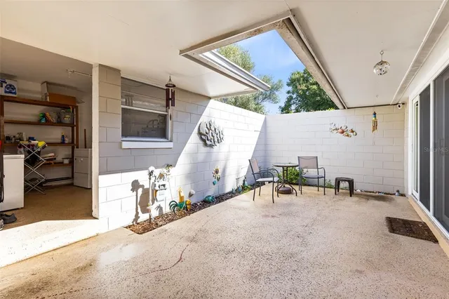 a view of a patio with a table and chairs