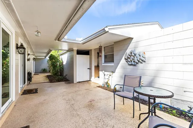 a view of a house with backyard and sitting area