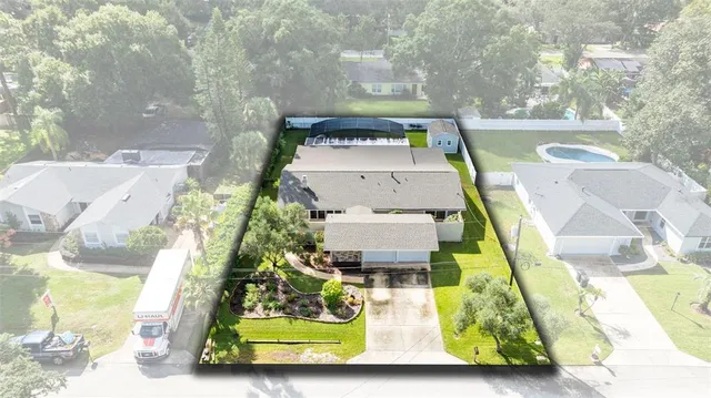 an aerial view of a house with a swimming pool