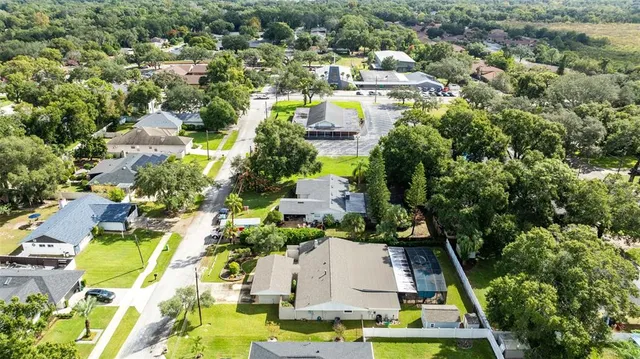 an aerial view of residential houses with outdoor space and swimming pool