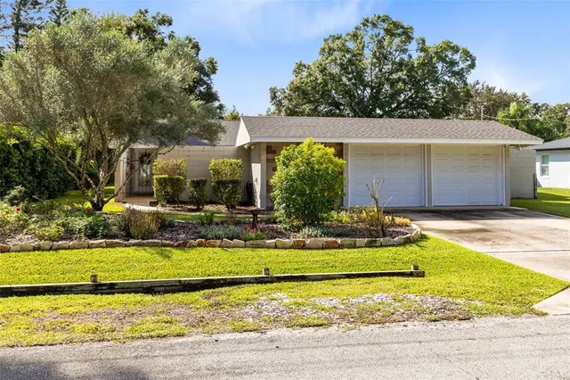 a view of a house with swimming pool and a yard