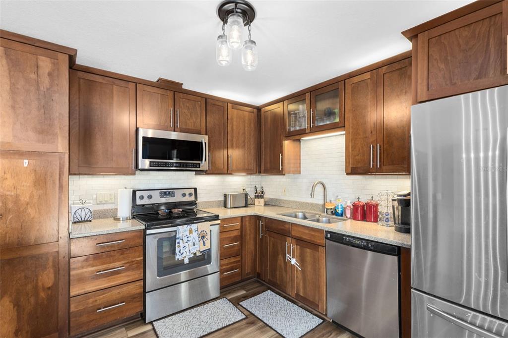 440 East Orange Street Altamonte Springs, FL 32701 - Photo 6 of 39 a kitchen with a sink stainless steel appliances and cabinets