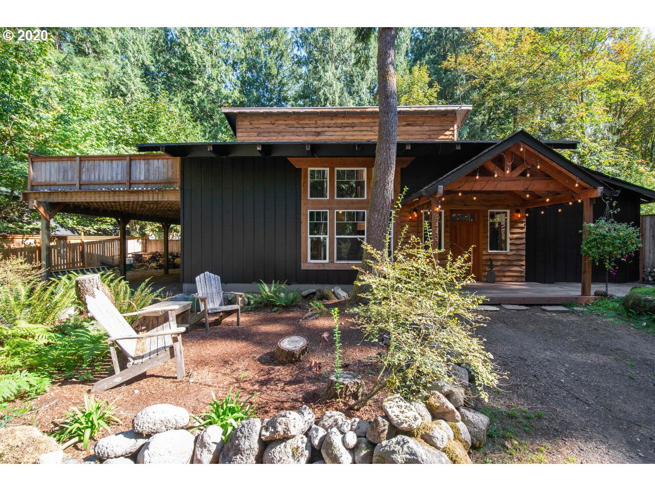 27780 East John Lake Road Rhododendron, OR 97049 - Photo 1 of 32 a front view of a house with garden