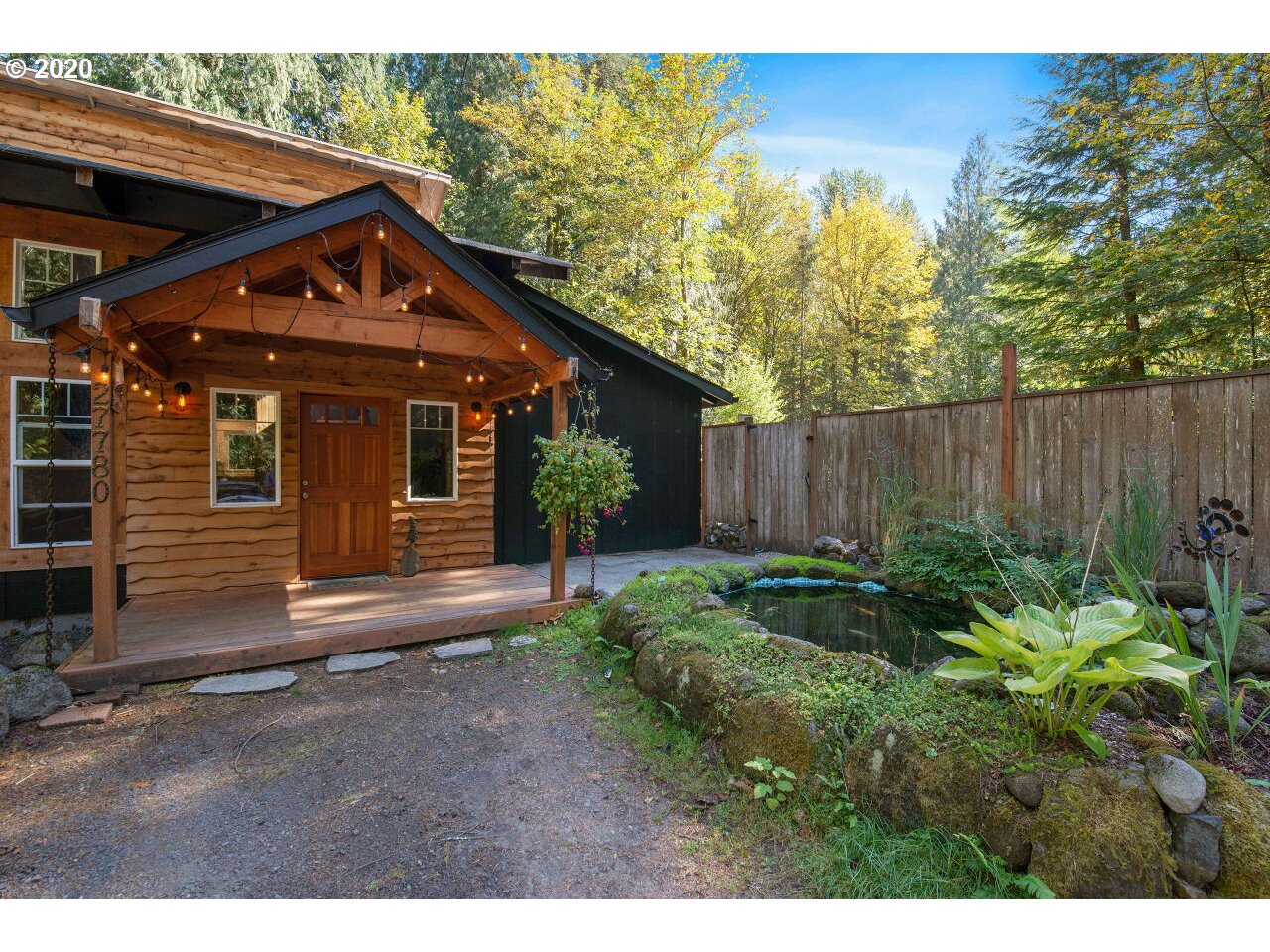 27780 East John Lake Road Rhododendron, OR 97049 - Photo 2 of 32 a view of a house with wooden fence