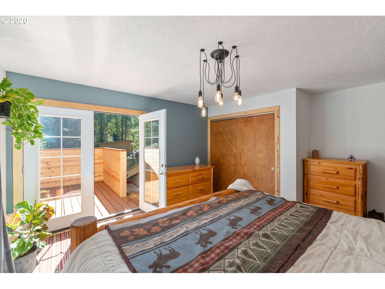 27780 East John Lake Road Rhododendron, OR 97049 - Photo 22 of 32 a bedroom with a bed and a dresser
