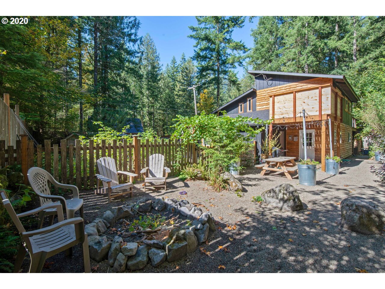 27780 East John Lake Road Rhododendron, OR 97049 - Photo 26 of 32 a view of a patio with chairs and potted plants