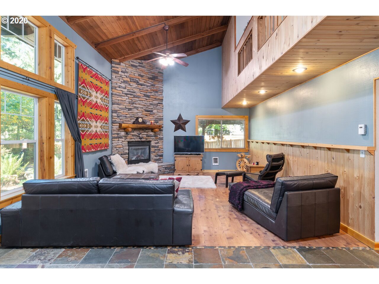 27780 East John Lake Road Rhododendron, OR 97049 - Photo 5 of 32 a living room with fireplace furniture and a large window