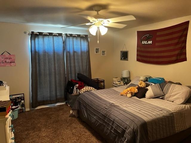 9104 Ridgely Avenue Lubbock, TX 79424 - Photo 15 of 19 a bedroom with a bed and a chandelier