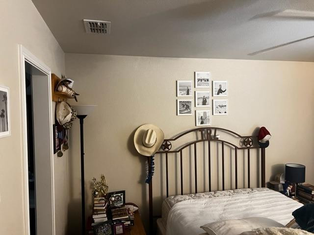 9104 Ridgely Avenue Lubbock, TX 79424 - Photo 18 of 19 a bedroom with a bed and a mirror in it
