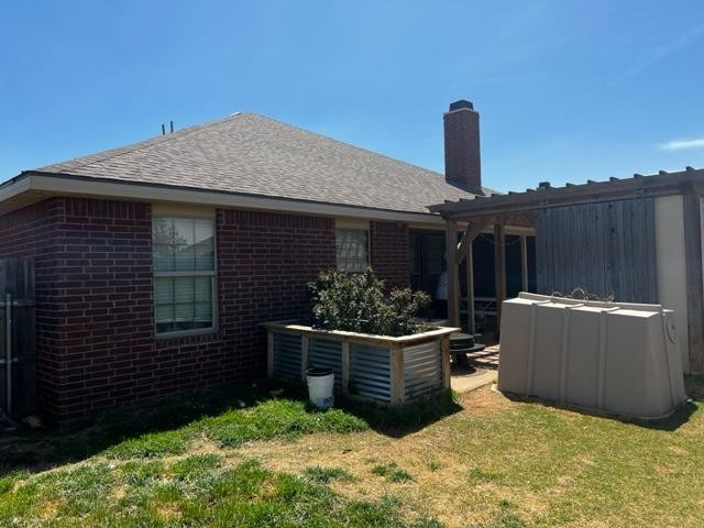 9104 Ridgely Avenue Lubbock, TX 79424 - Photo 3 of 19 a backyard of a house with potted plants