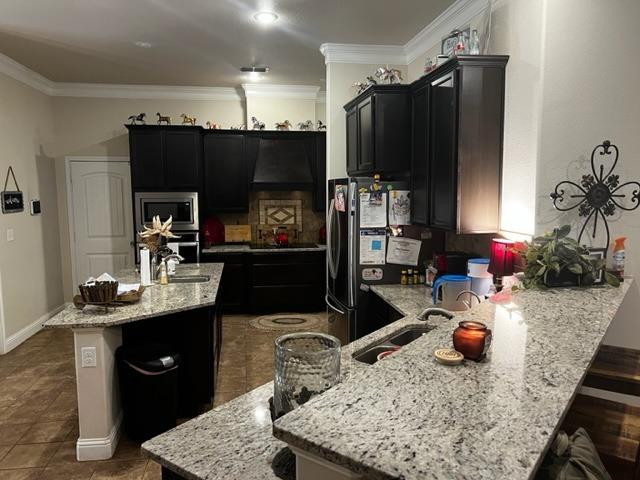 9104 Ridgely Avenue Lubbock, TX 79424 - Photo 6 of 19 a kitchen with a sink refrigerator and cabinets