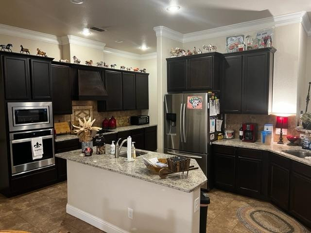 9104 Ridgely Avenue Lubbock, TX 79424 - Photo 7 of 19 a kitchen with granite countertop a refrigerator and a stove top oven