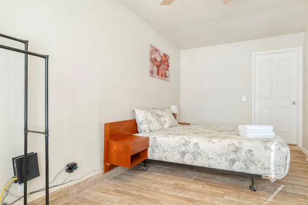 a bedroom with a bed and a chair